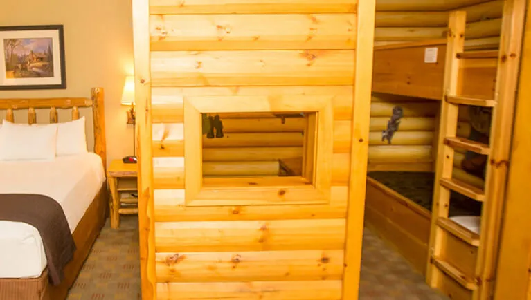 The bed and indoor cabin with bunk beds in the accessible KidCabin Suite 